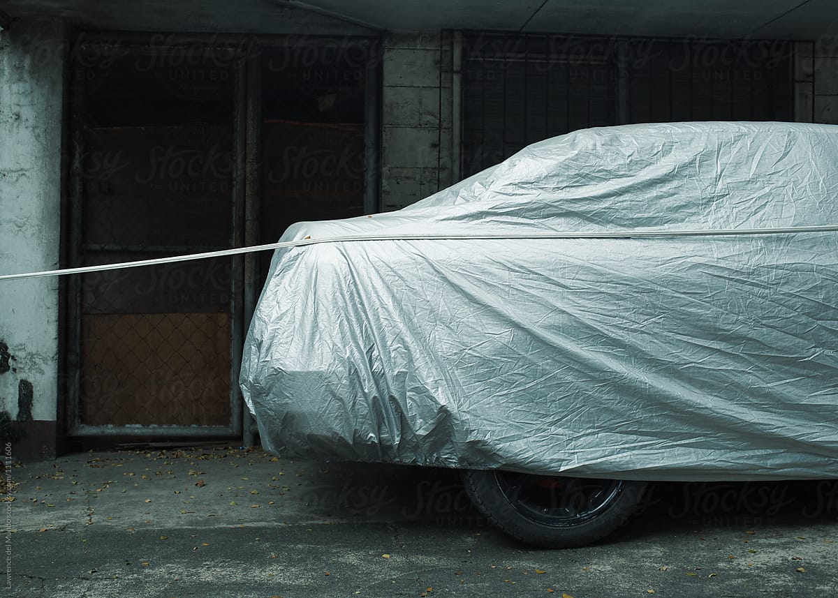 A covered parked, idle car.