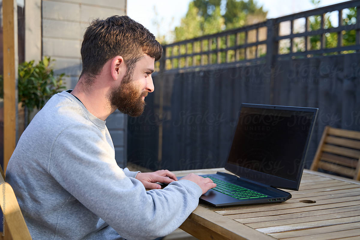 Man works from home at garden table