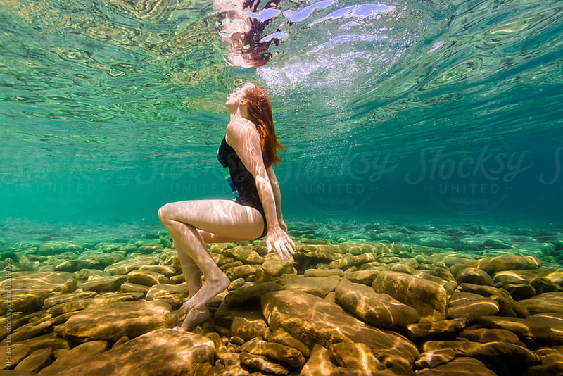 Woman Swimming Underwater In Clean Summer Lake