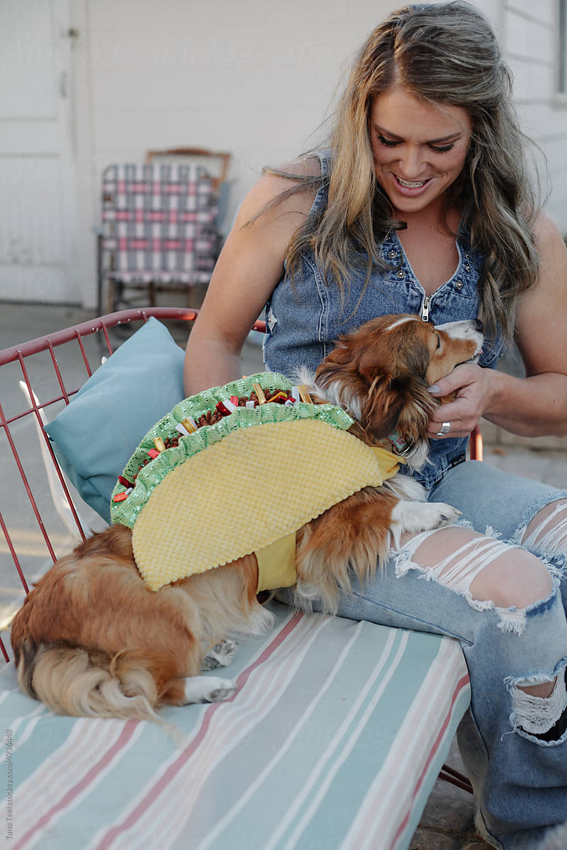 woman dresses dog in taco costume for Halloween