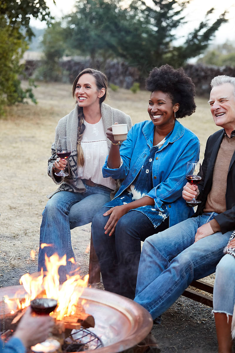 Group of multigenerational friends around a fire