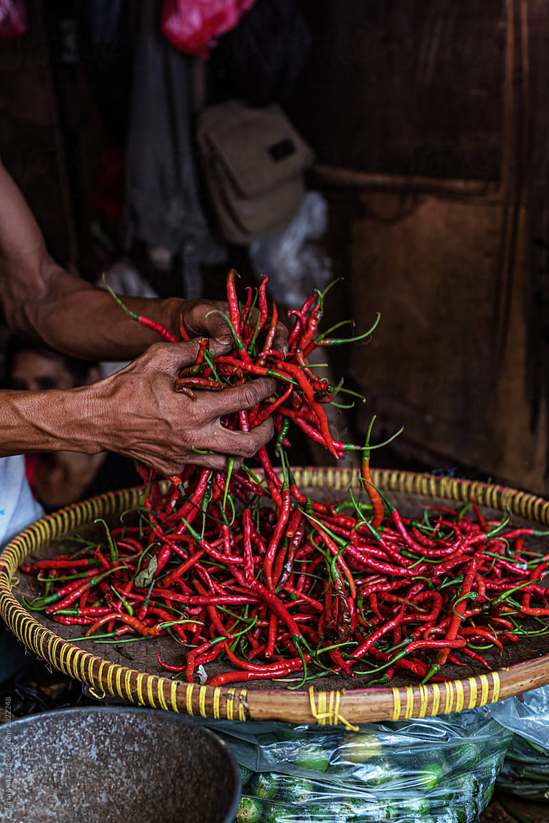 Holding fresh chili peppers in an Indonesian market