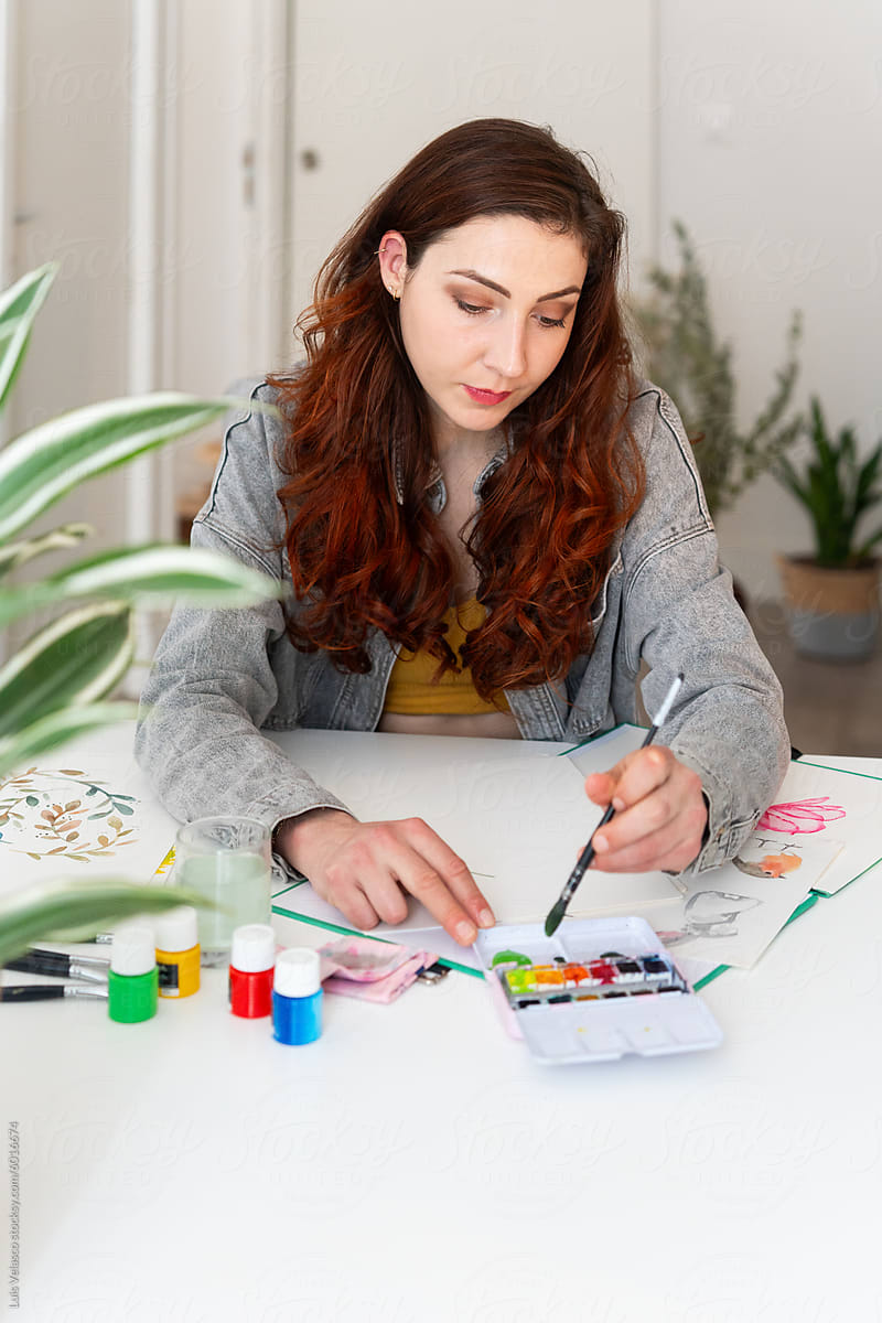 Young Woman Painting A Illustration At Home.