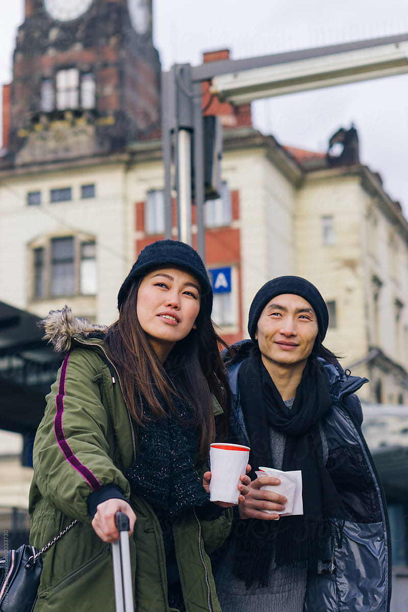 Asian couple waiting for a train in European city