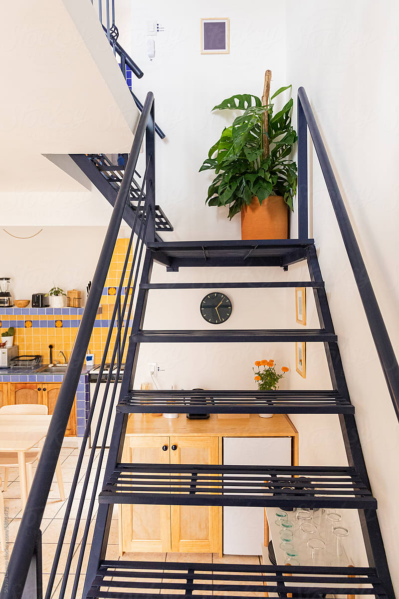 A staircase with a clay pot at the background in an apartment