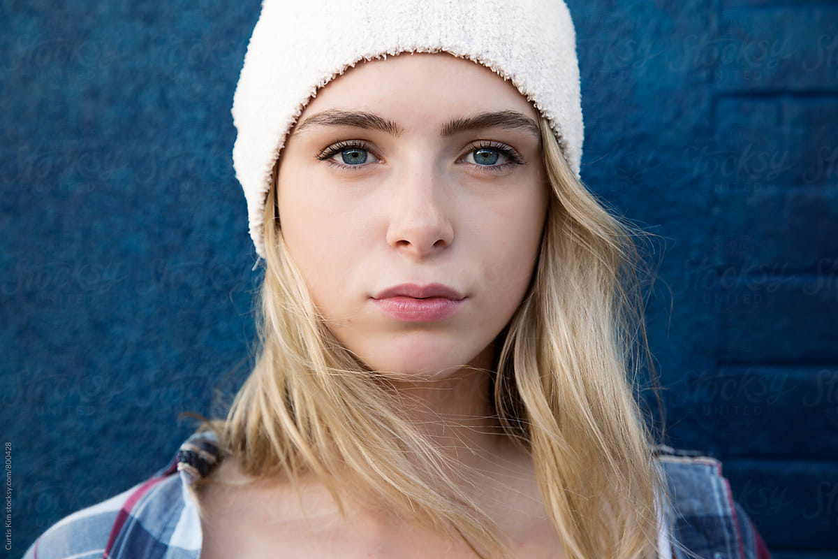 Pretty Teen Girl With Long Blonde Hair Wearing A White Beanie By