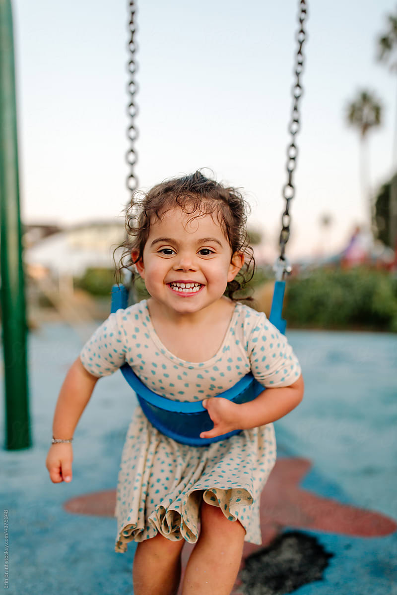 Young girl with limb difference on swing