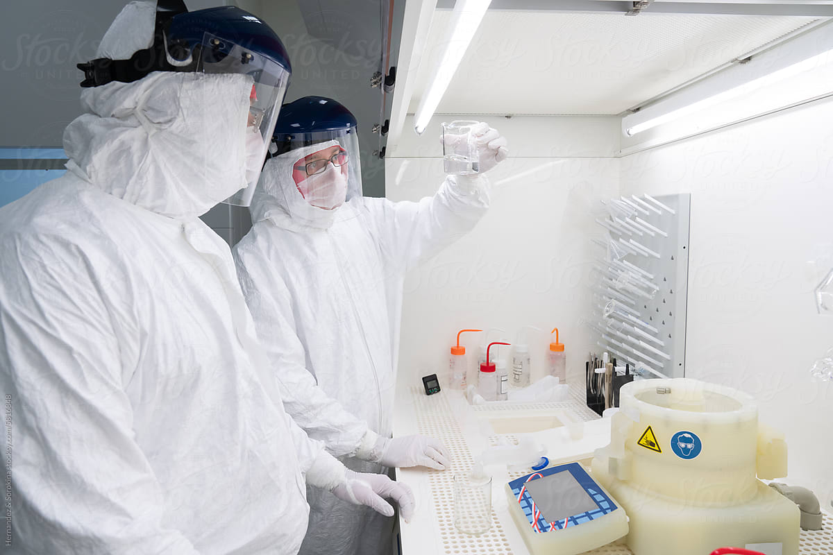 Two Researchers Working In Chamber At Clean Room