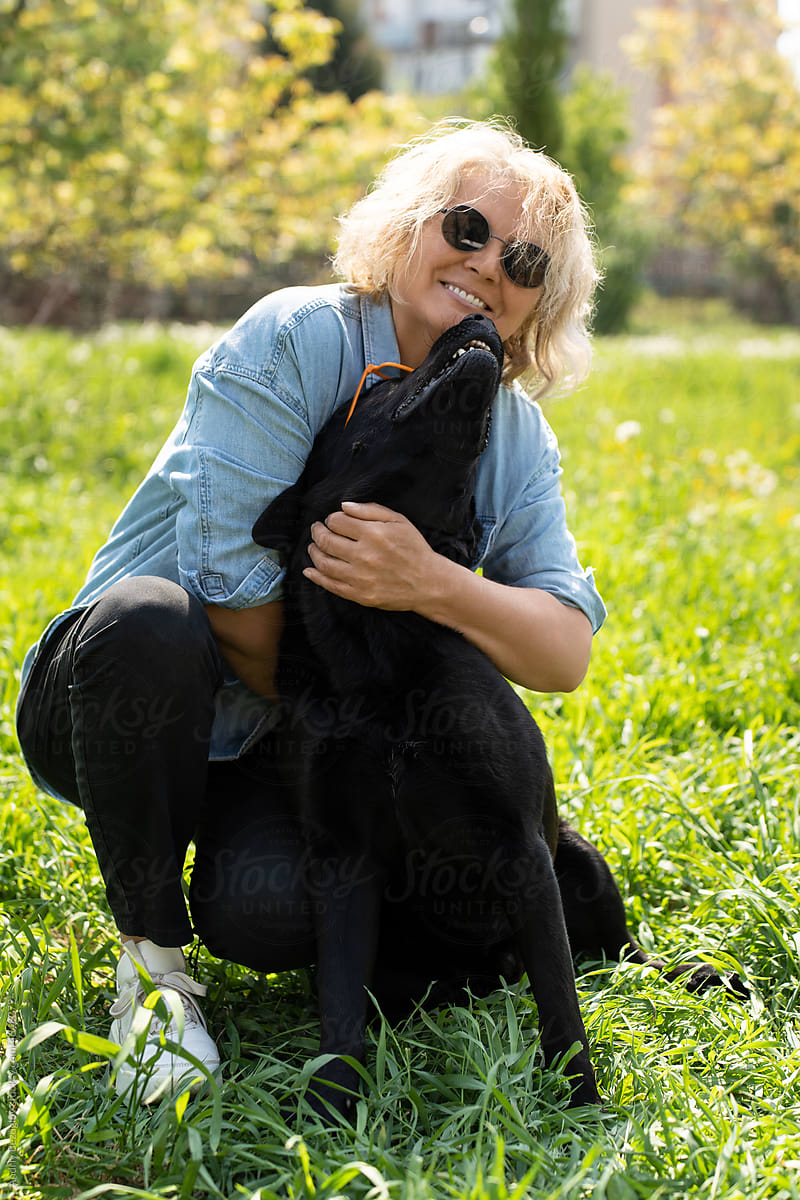 Portrait of lady with humorous dog in glasses
