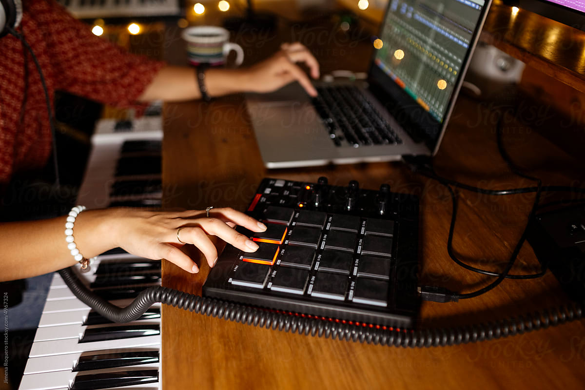 Anonymous audio producer using midi pad controller at home studio