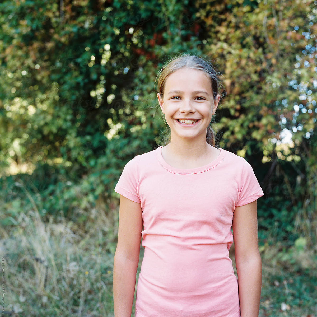 Preteen Girl Smiling Outdoors By Stocksy Contributor Carleton