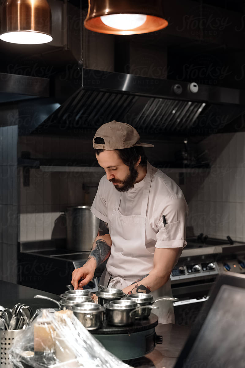 Bearded chef working in restaurant kitchen