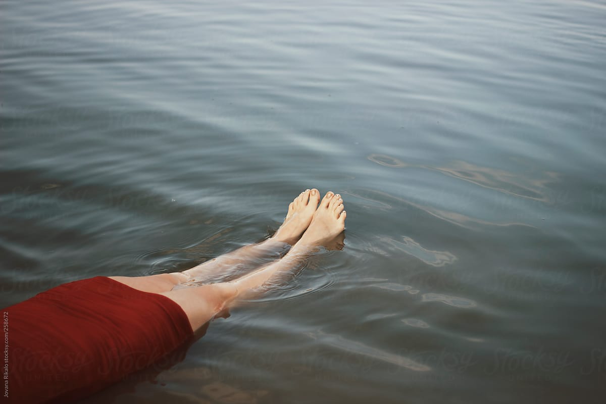 Womans feet floating in water