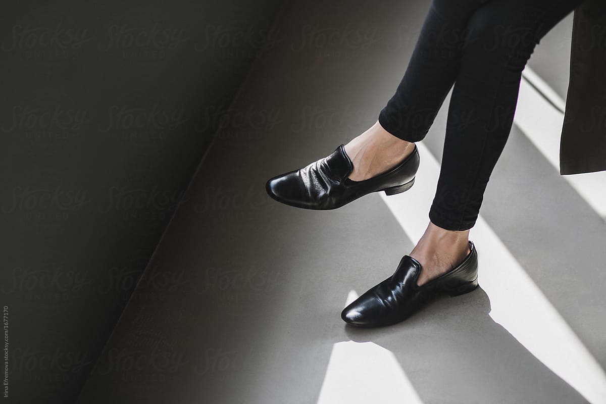 Black pants, black shoes, gray floor