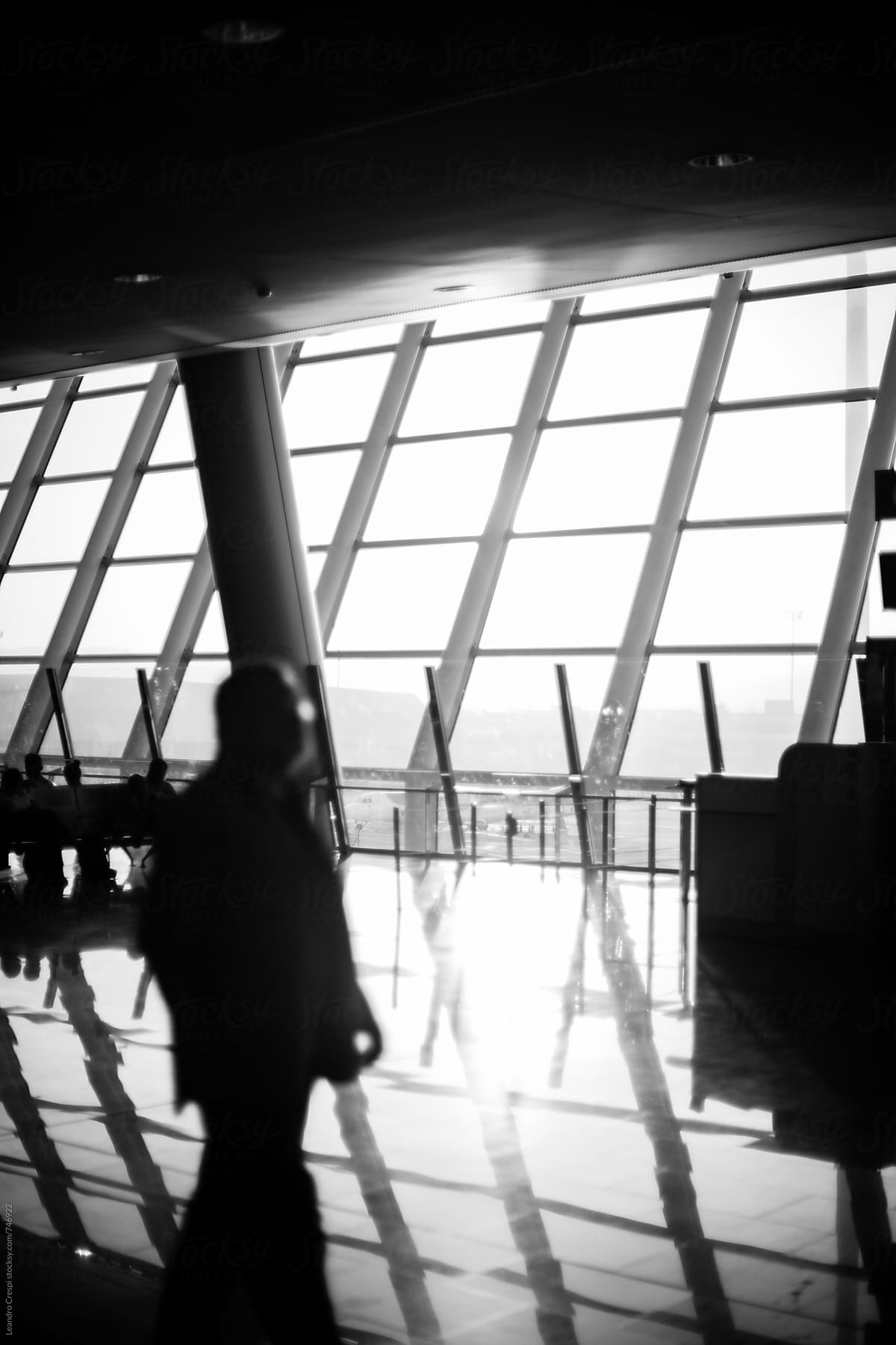 Black and white scene of people commuting in an airport