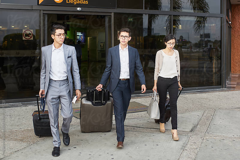 Young entrepreneurs leaving the airport with luggage