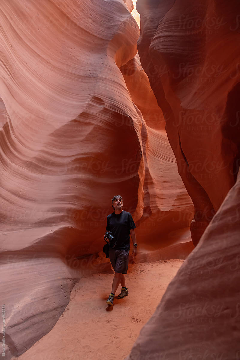 Man venturing into a narrow canyon in Arizona