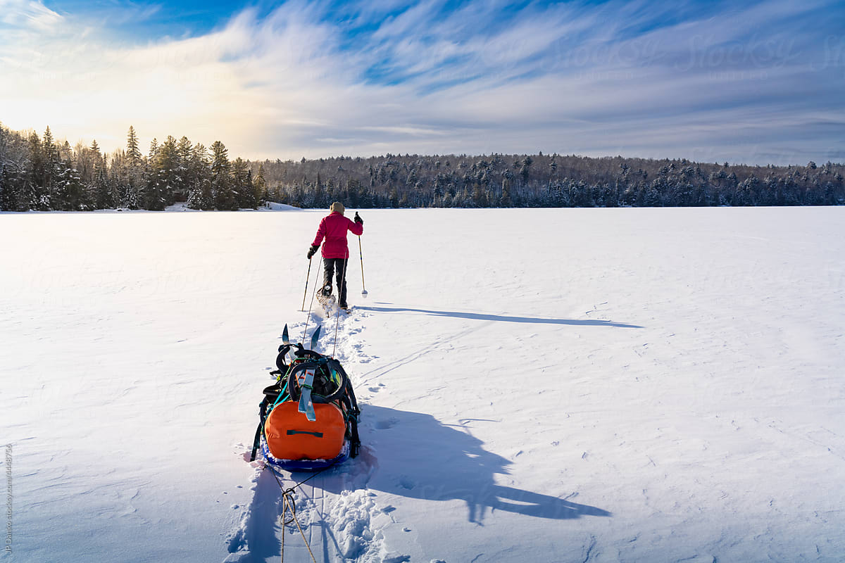 Pulling Winter Camping Gear Across Frozen Lake