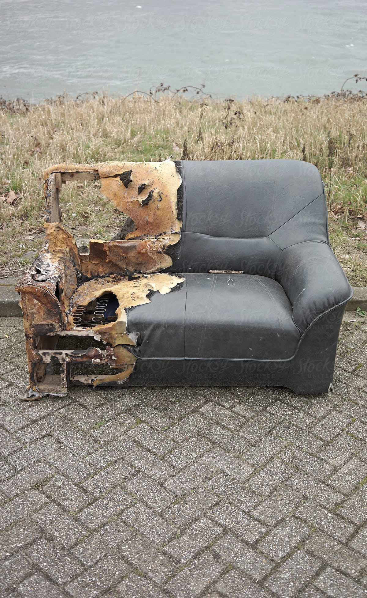 Old burned couch on the street