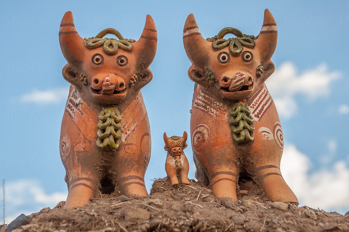 Clay cows on top of a house in Peru