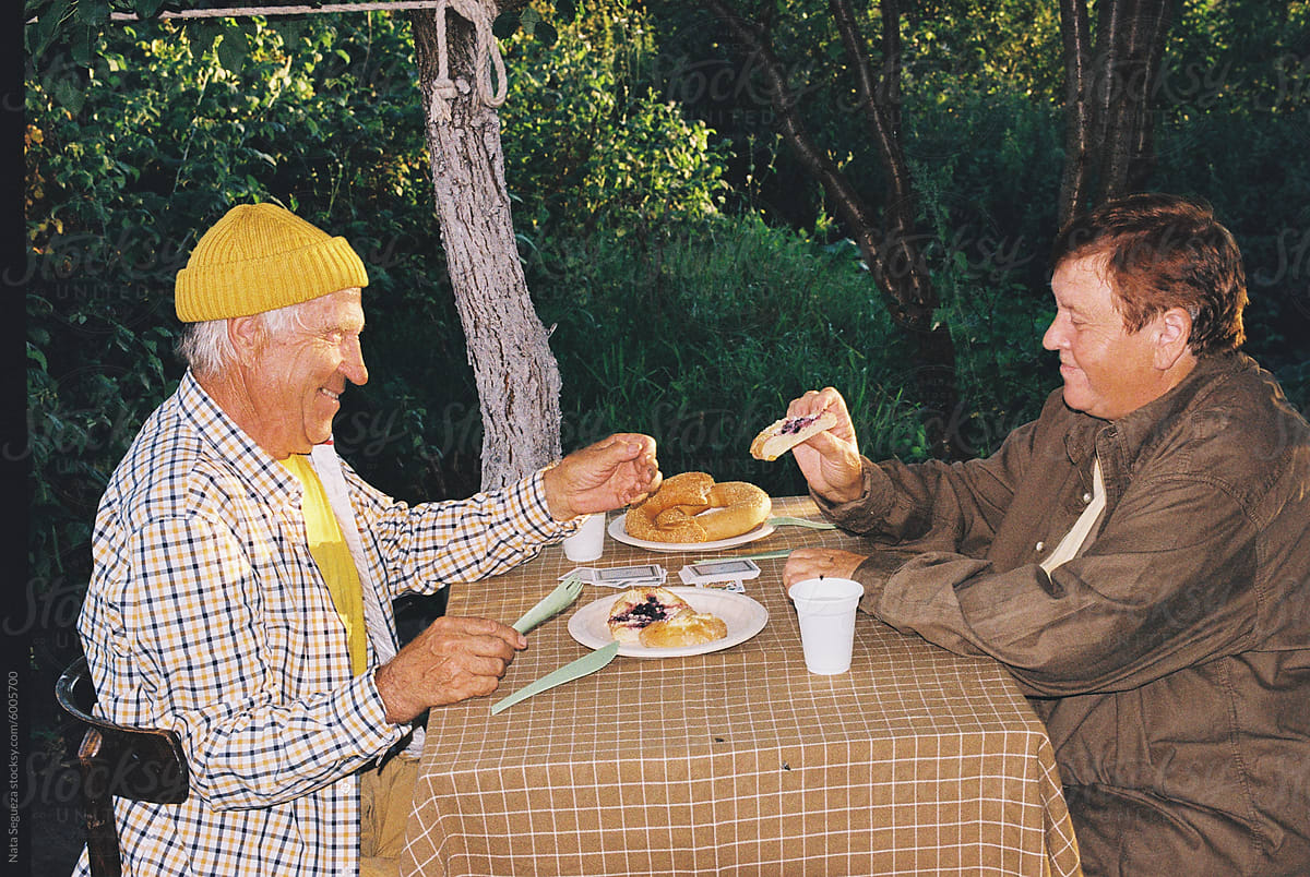 A man and a woman enjoy an al fresco breakfast in the garden