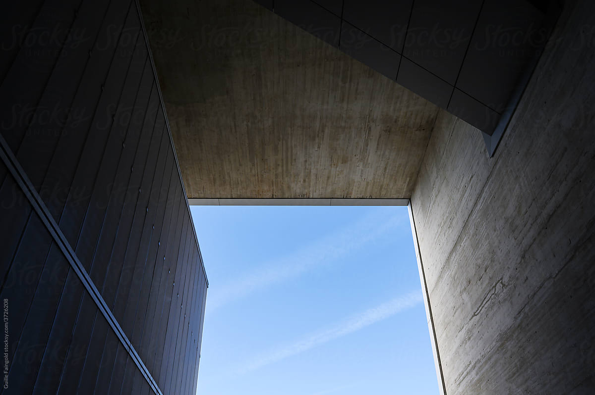 Inner passage of building under blue sky