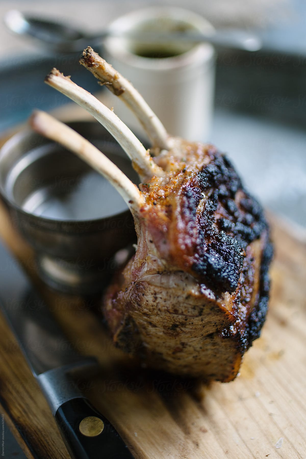 Rack of lamb on wooden board, selective focus.