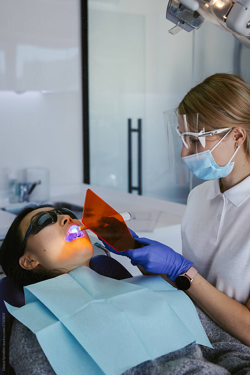 Female dentist  treating patient in a dental office