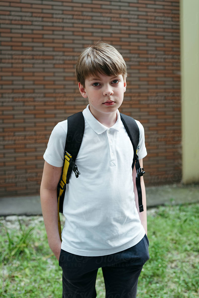 Portrait of young schoolboy with backpack.