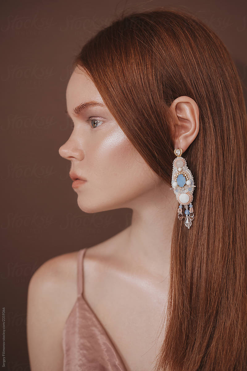 Beautiful ginger woman with luxury earrings