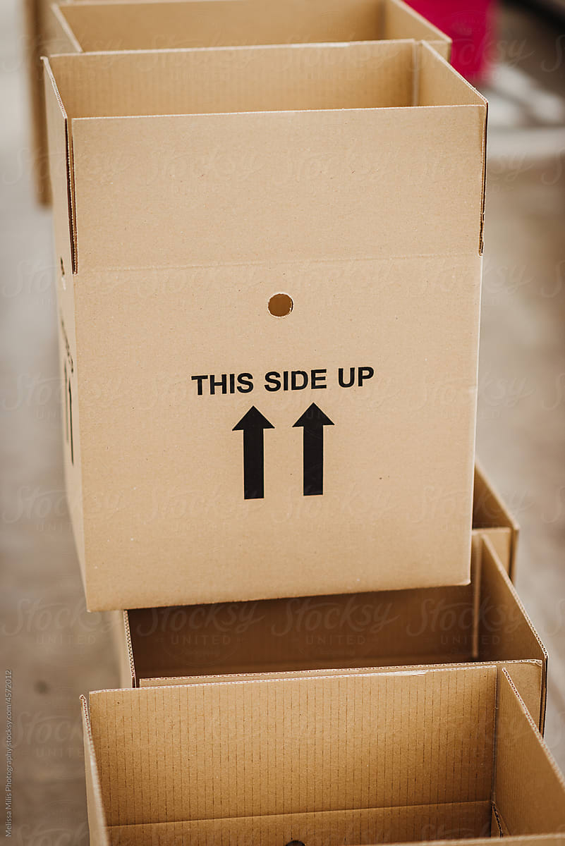 Cardboard boxes saying \'this side up\'