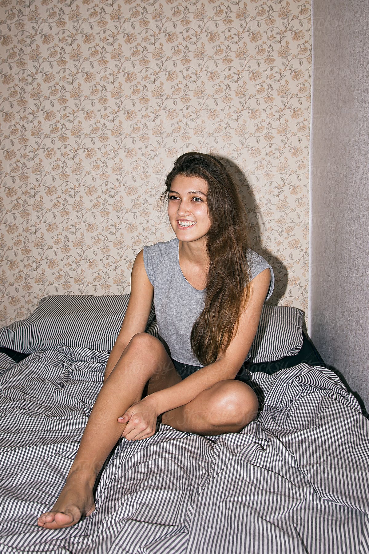 Young woman on bed at home