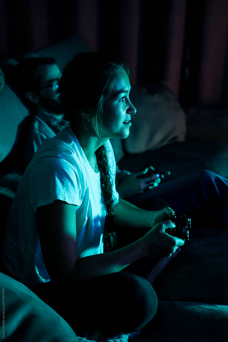 Happy couple playing videogames at night