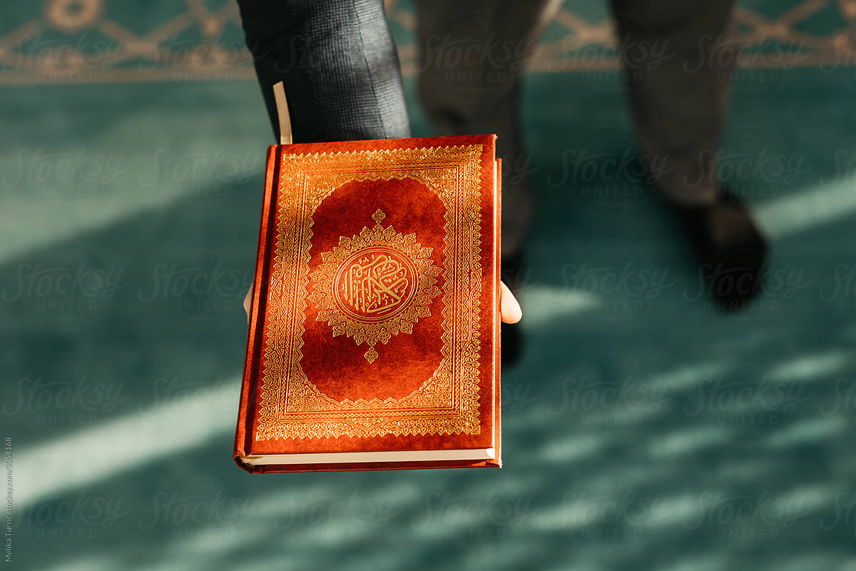 Top view of a man holding Quran