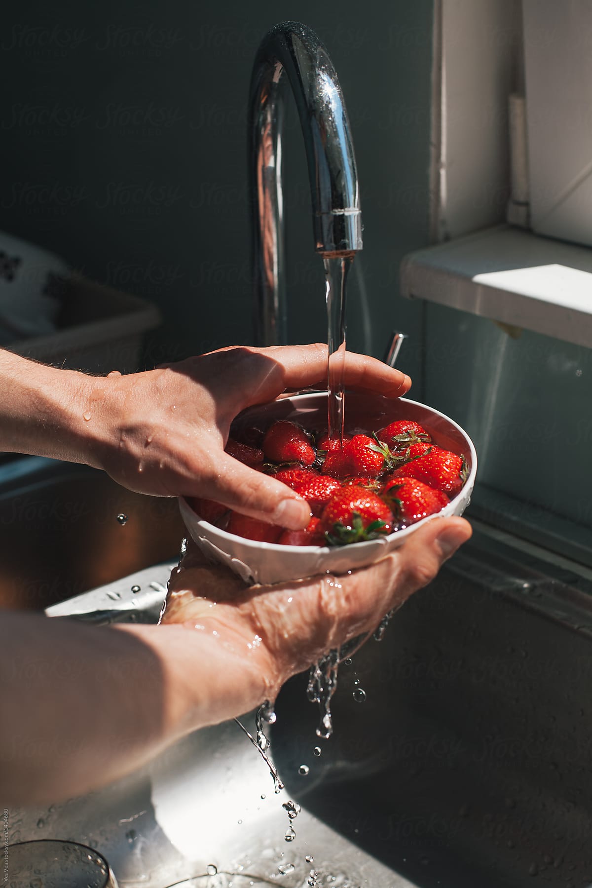 Man rinsing strawberries