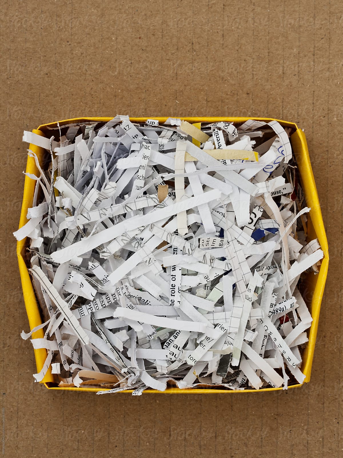 Shredded paper in a box on cardboard