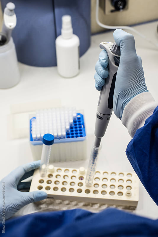 Female scientist using a pipette in a DNA laboratory