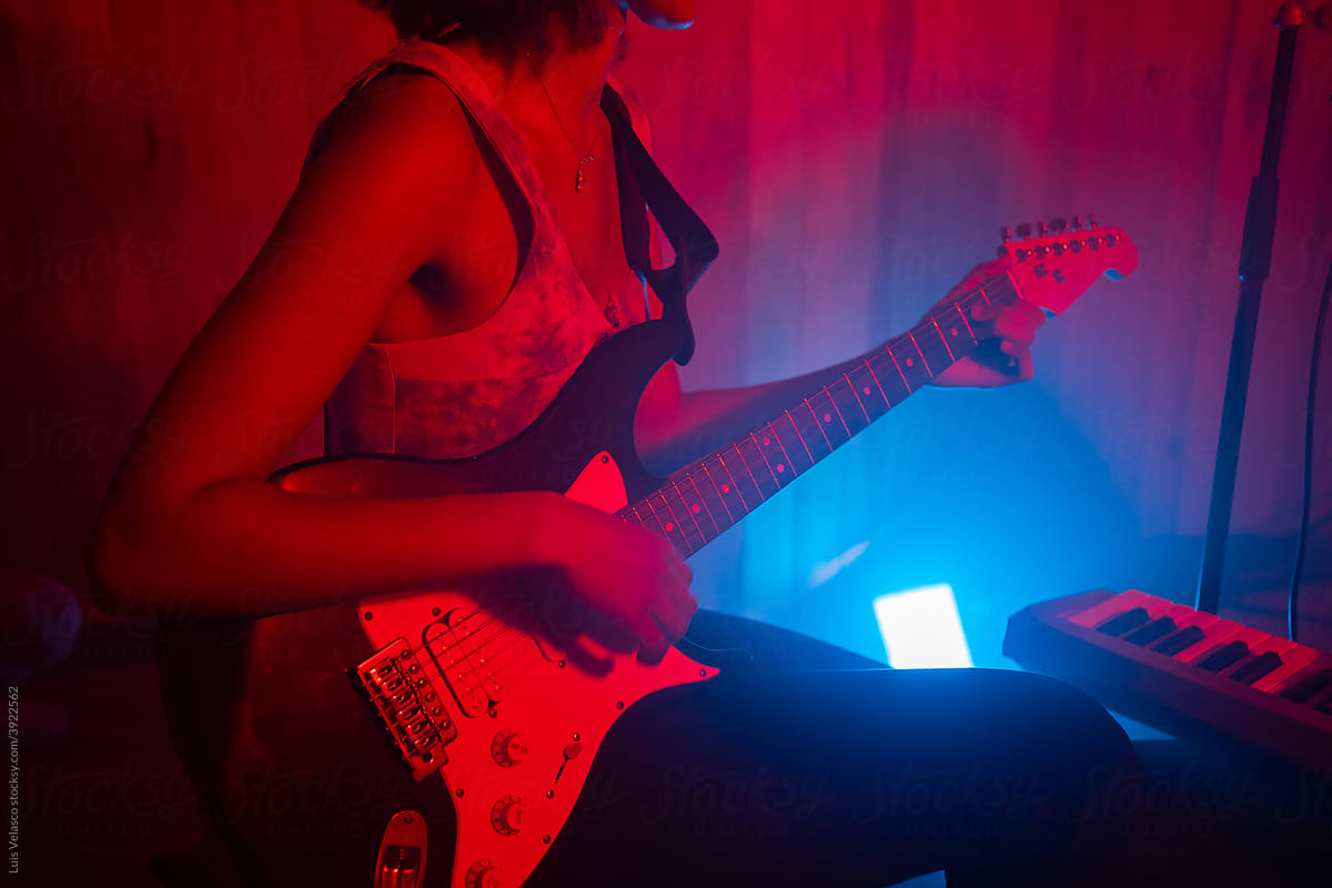 Headless Woman Playing The Guitar In The Studio.