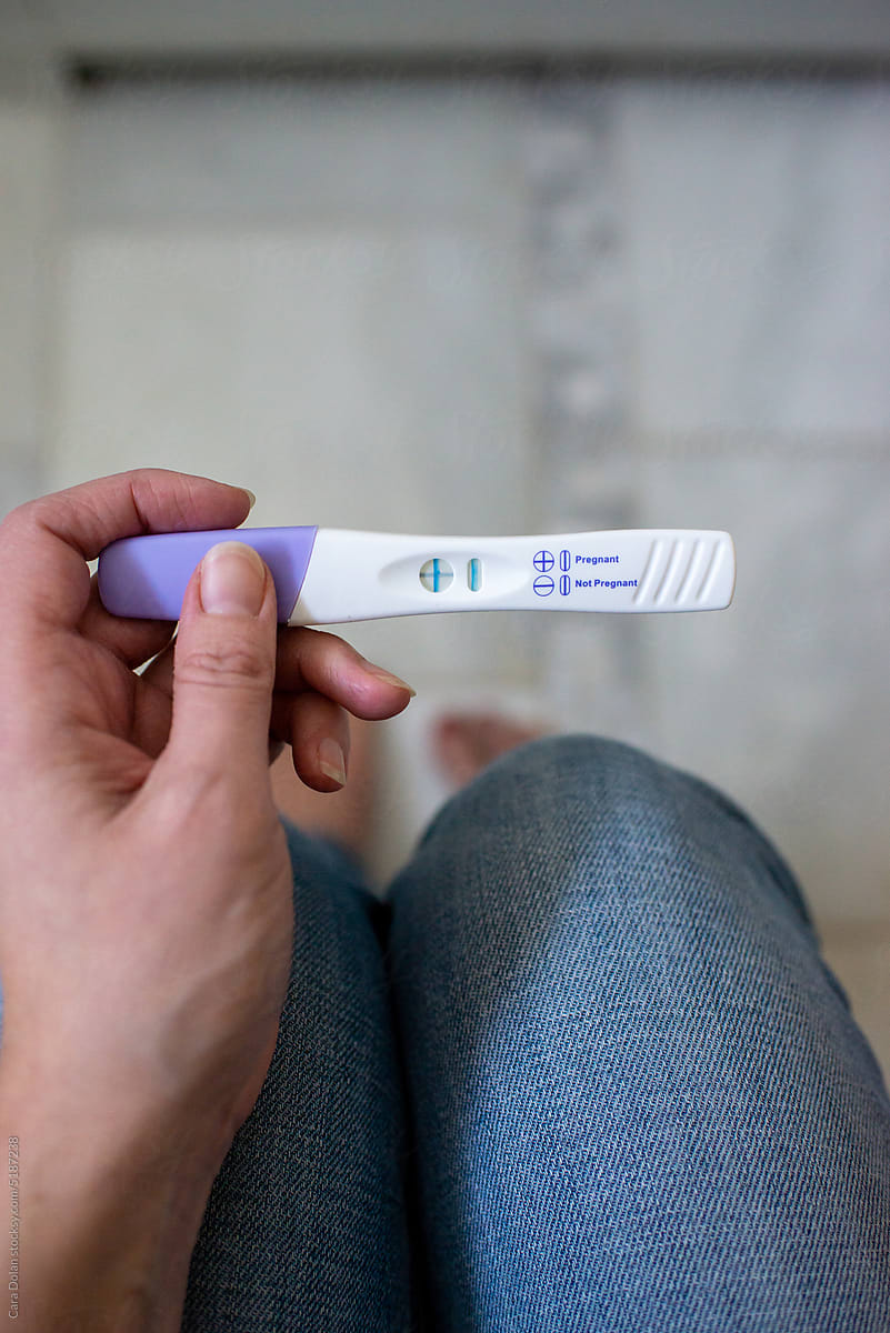 Mom-to-Be Holding Positive Pregnancy Test in her Hands