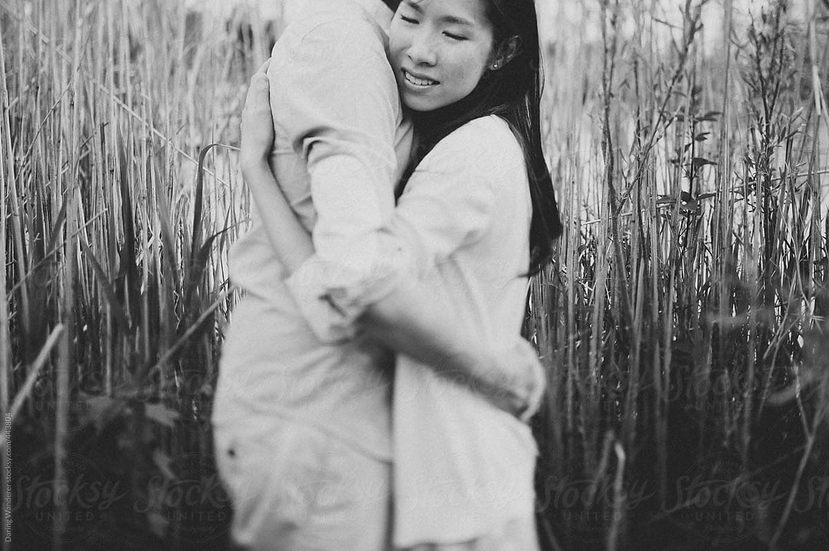 Newly Engaged Young Asian Couple Hugging And Smiling By Stocksy Contributor Jess Craven 