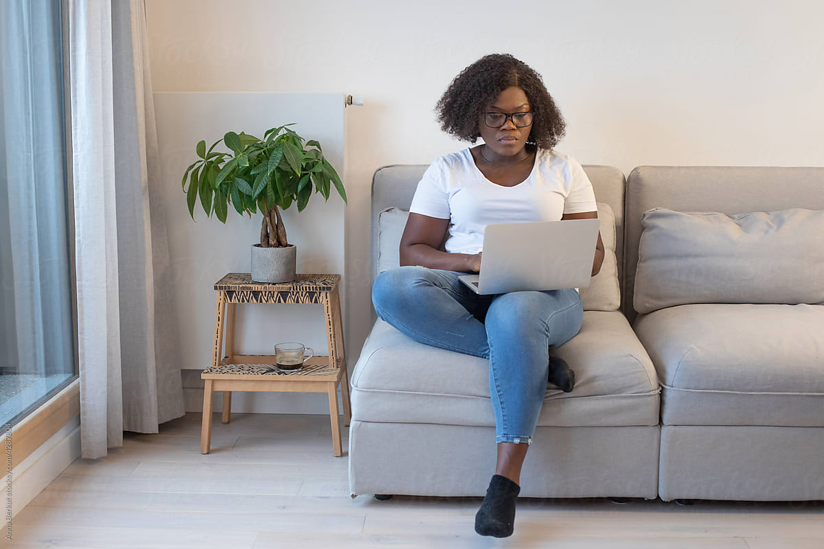 black woman using laptop computer at home, job search