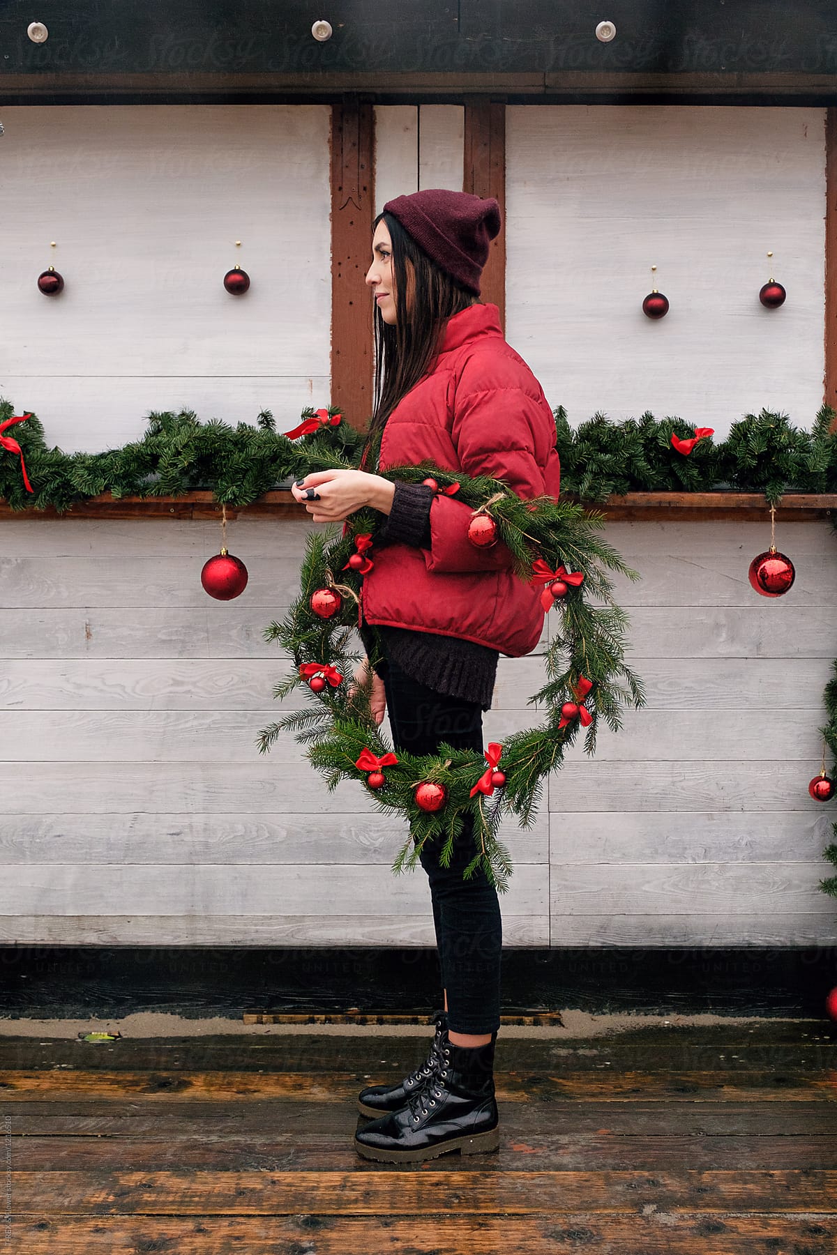 Side view of female with Christmas wreath