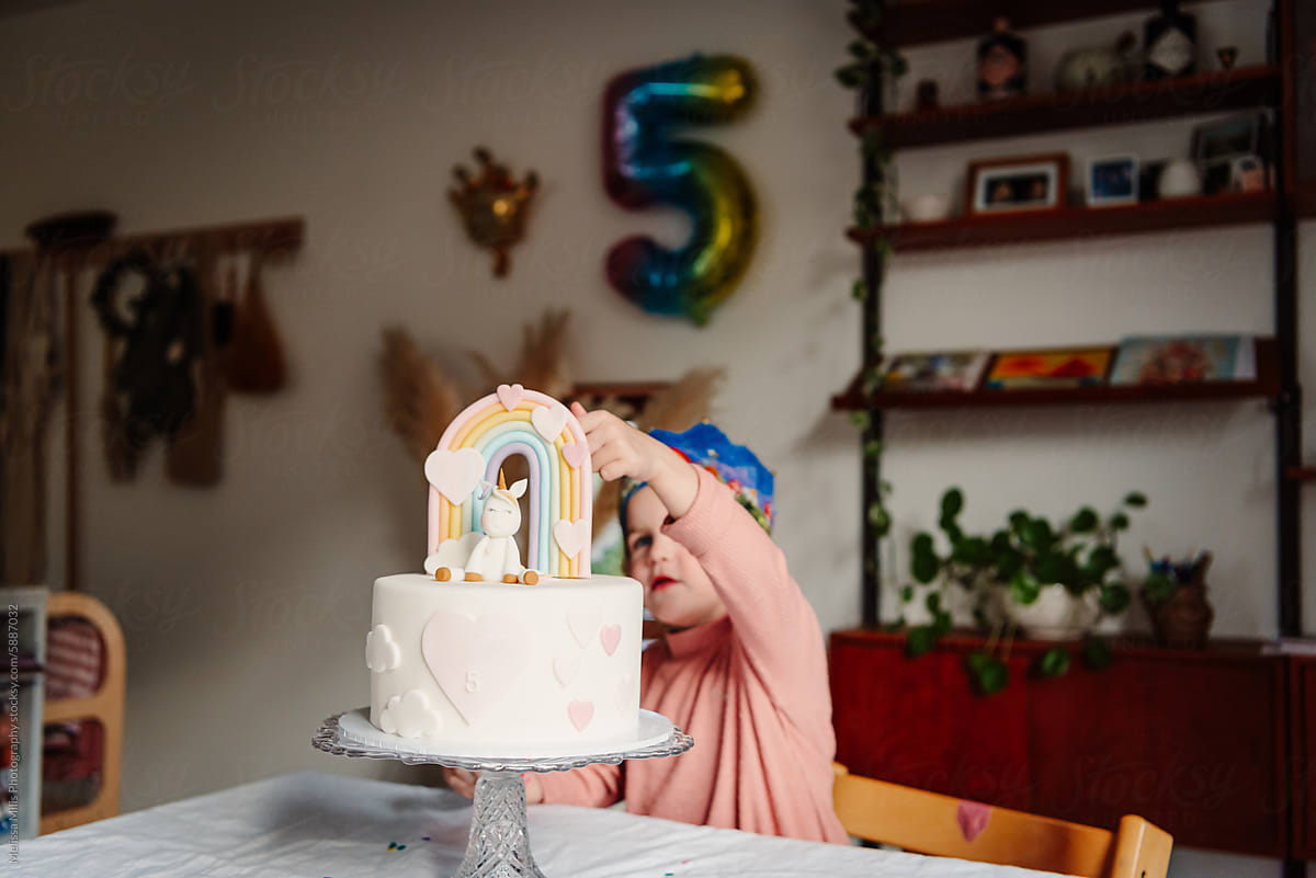 Girl at home exploring her handmade cake for birthday