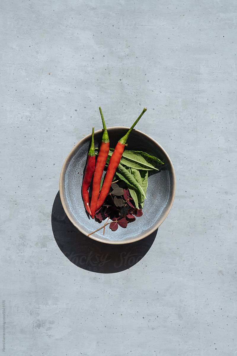Red hot Chili peppers and greenery in bowl