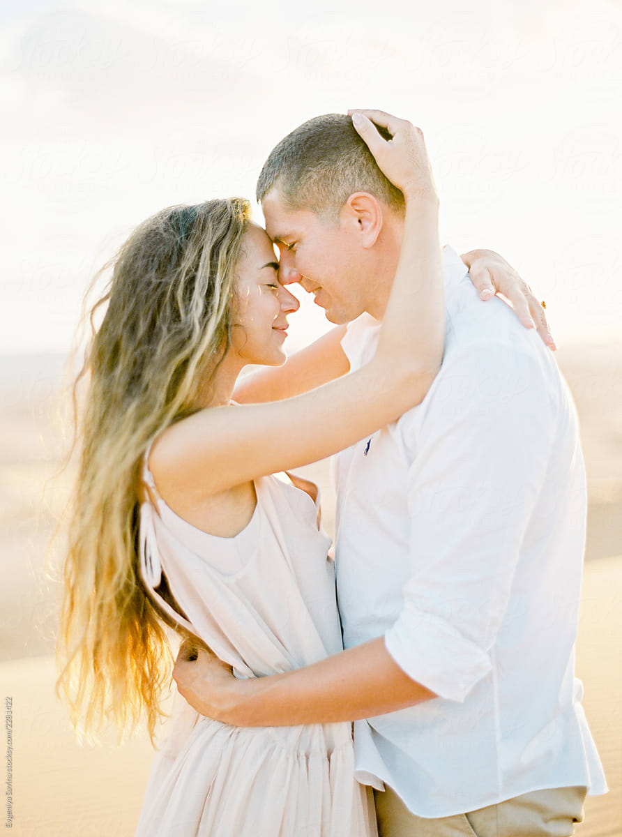 A Loving Couple Kissing In The Sunset By Stocksy Contributor