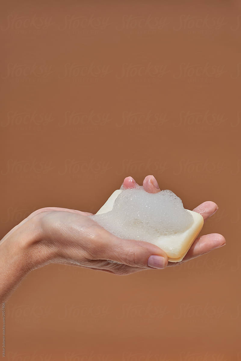 Crop woman showing foamy soap