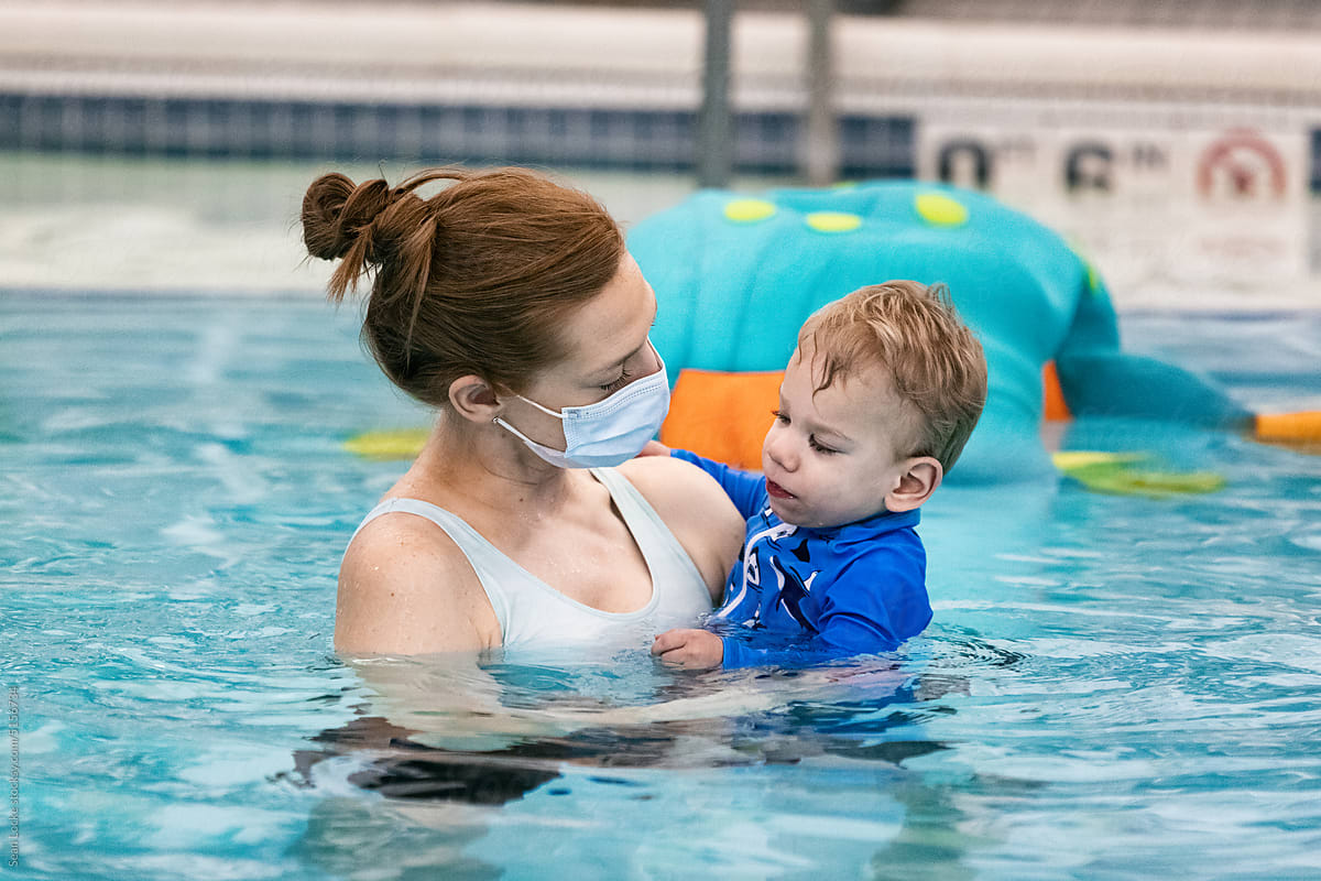 Physical Therapist Holds Cerebral Palsy Patient In Pool
