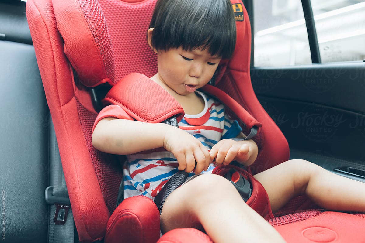 asian little girl(2-3) in a car