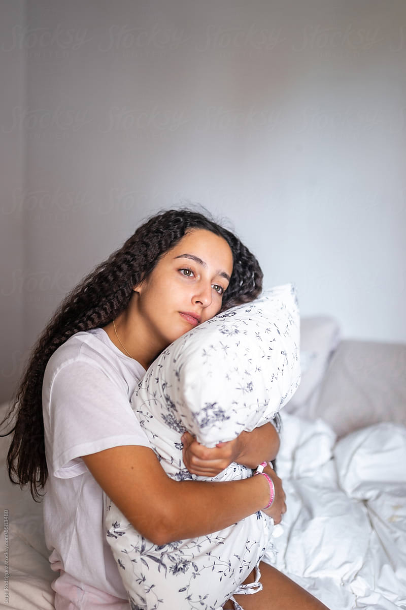 portrait of teen girl with curly hair in her bedroom