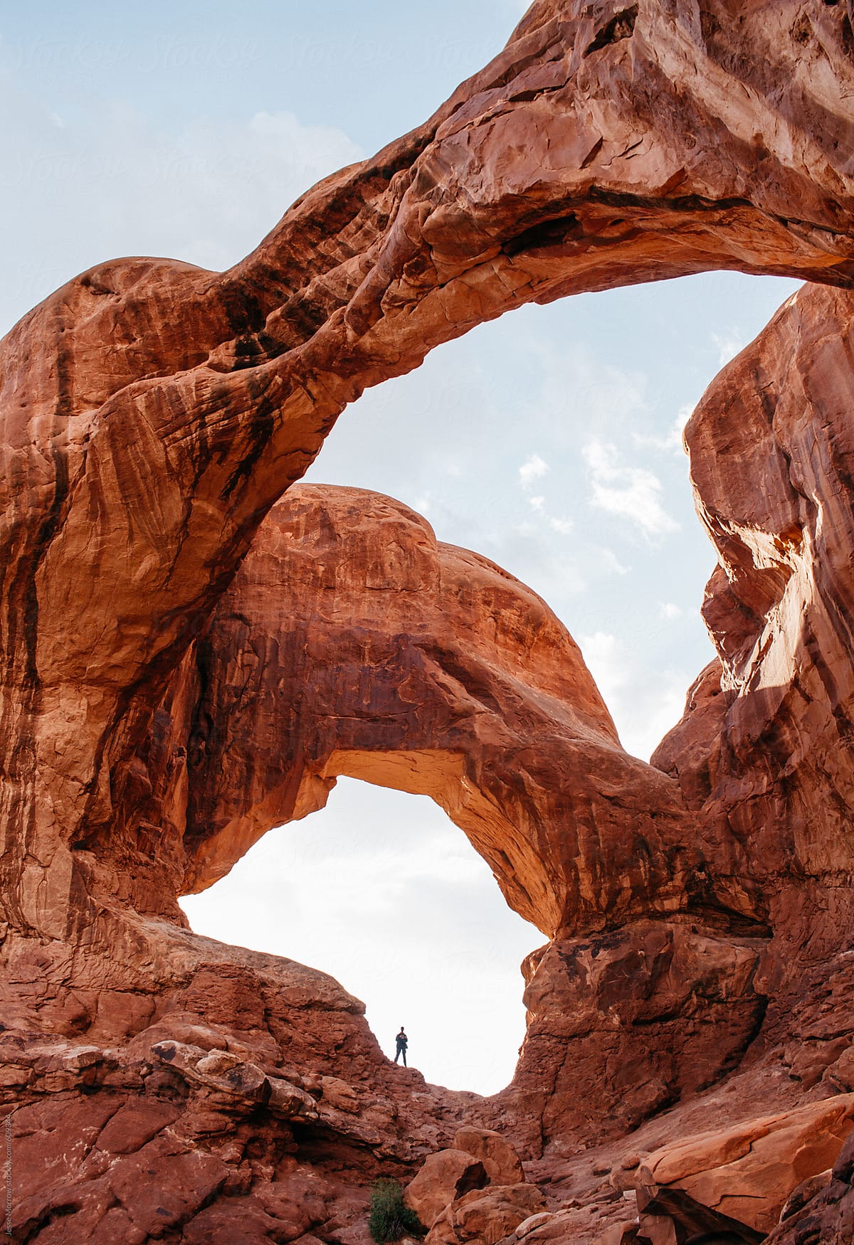 human standing in double arches red rock southwest desert usa